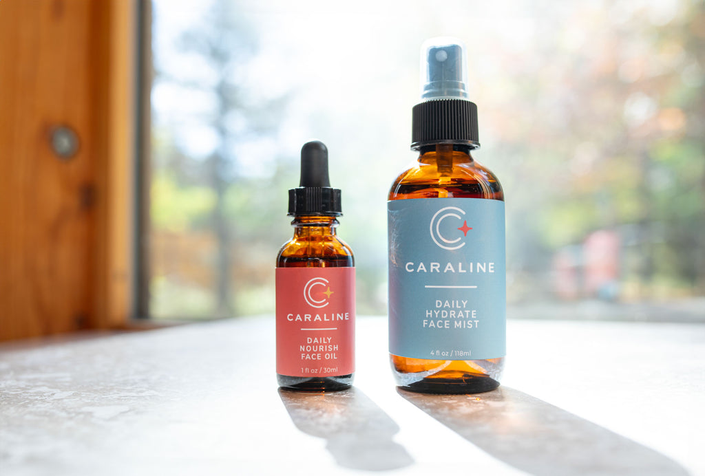 Bottles of Caraline Daily Nourish Face Oil and Daily Hydrate Face Mist 