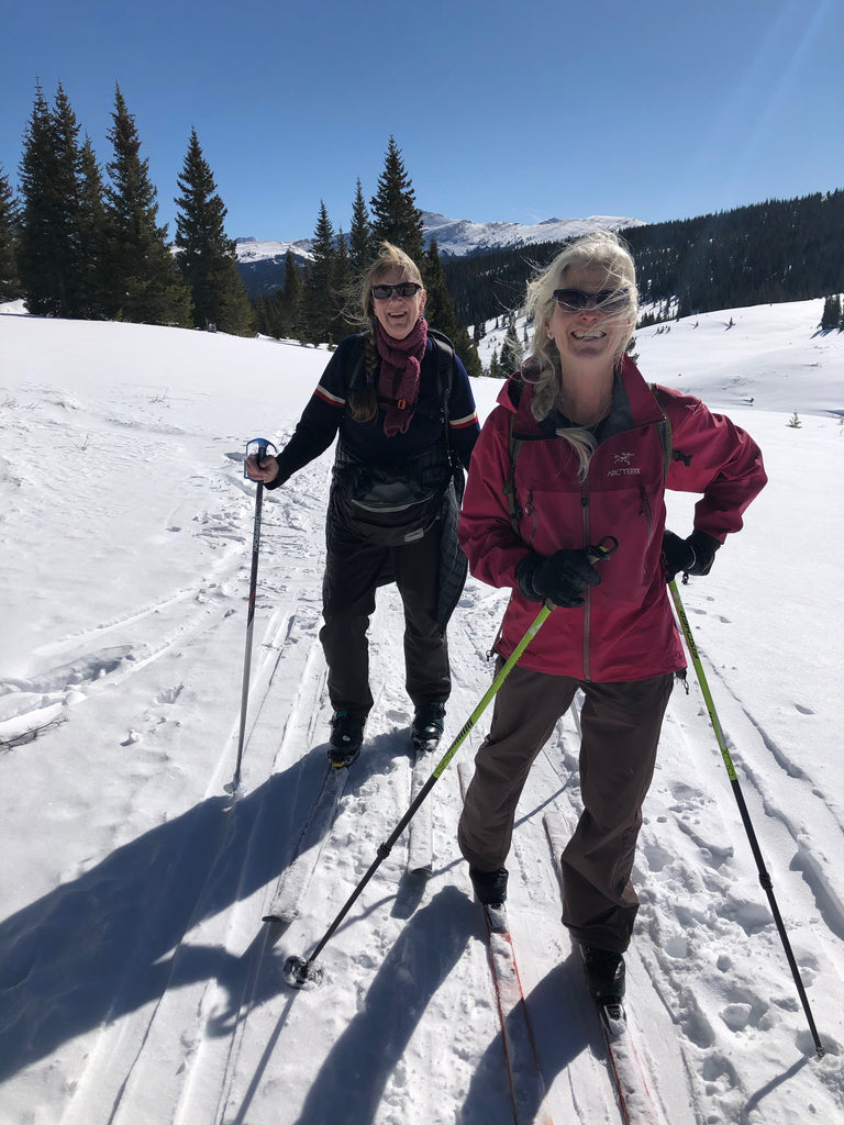 Two older women cross-country skiing