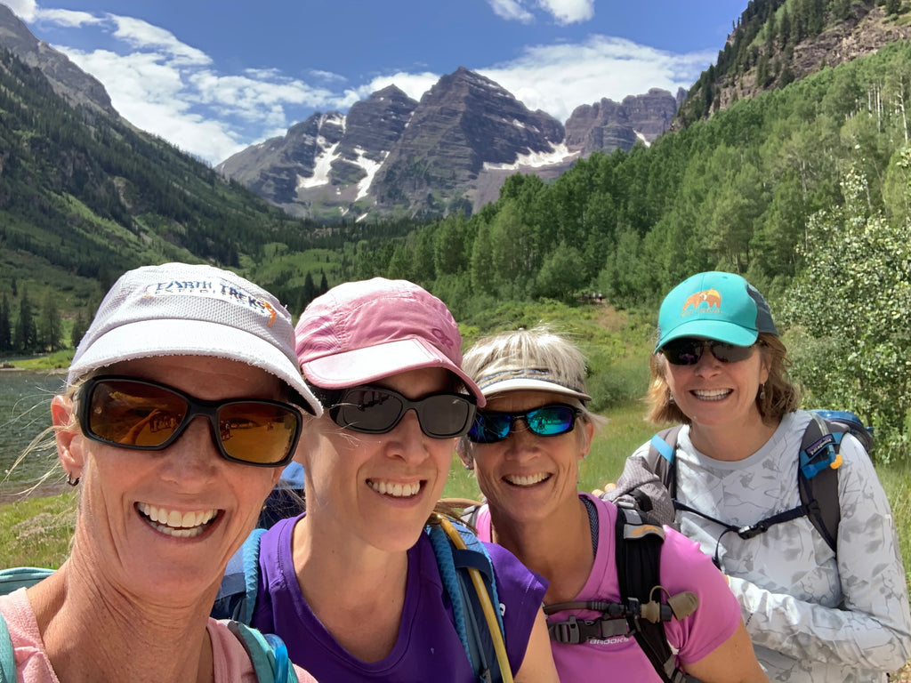 Group of active older women hiking at the Maroon Bells in Aspen, smiling at the camera