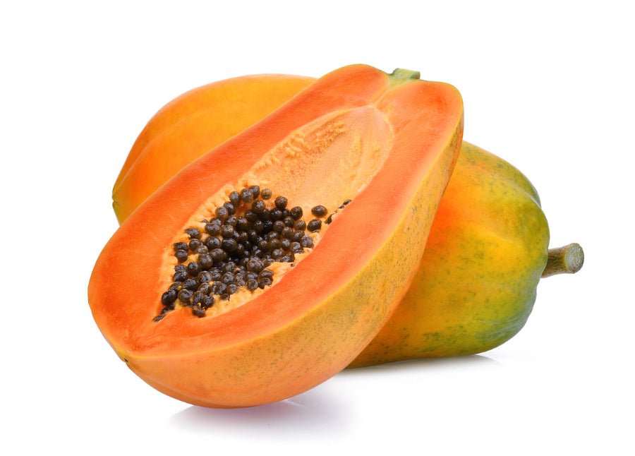 Papaya fruit sliced in half with seeds